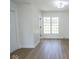 Bright bedroom with hardwood floors, trim, and a large window, creating a warm and inviting space at 5707 In-234, McCordsville, IN 46055