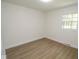 Bedroom with a large window, laminate flooring and trim at 5707 In-234, McCordsville, IN 46055