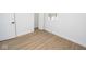Bright bedroom with wood floors, white trim, and natural light from window at 5707 In-234, McCordsville, IN 46055