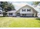 Charming two-story home with painted brick, dark shutters, fresh landscaping, and a green lawn at 5707 In-234, McCordsville, IN 46055
