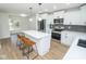 Modern kitchen with white cabinets, quartz countertops, black herringbone backsplash, stainless steel appliances, and a center island at 5707 In-234, McCordsville, IN 46055