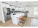 Beautiful modern kitchen with a large center island, stainless steel appliances, white cabinetry, and sleek pendant lighting at 5707 In-234, McCordsville, IN 46055