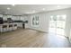 Spacious living area with luxury vinyl flooring, open to a contemporary kitchen with a center island, and access to the backyard at 5707 In-234, McCordsville, IN 46055