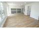 Spacious living room with hardwood floors, large windows, and white trim, offering natural light at 5707 In-234, McCordsville, IN 46055