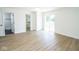 Bright bedroom with hardwood floors, a closet, and sliding glass doors to the exterior at 5707 In-234, McCordsville, IN 46055