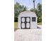 Exterior view of a shed with gray trim and white gravel at 5707 In-234, McCordsville, IN 46055