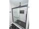 Modern walk-in shower featuring marble-look tiled walls and sleek glass door with black accents at 5707 In-234, McCordsville, IN 46055