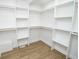 Spacious walk-in closet with custom white shelving and laminate flooring at 5707 In-234, McCordsville, IN 46055