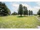 Expansive grassy yard with mature trees, offering a serene and inviting outdoor space at 5707 In-234, McCordsville, IN 46055