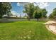 Spacious fenced backyard with manicured lawn, patio, and an outdoor storage shed at 5927 Meadowood Dr, Speedway, IN 46224