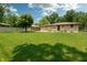 Expansive grassy backyard bordered by a fence and mature trees provides lots of room at 5927 Meadowood Dr, Speedway, IN 46224