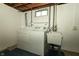 Basement laundry area including washer, dryer, and a utility sink at 5927 Meadowood Dr, Speedway, IN 46224
