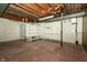 Unfinished basement with white walls, carpet and an exposed ceiling, ready for storage or to be finished at 5927 Meadowood Dr, Speedway, IN 46224