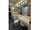 Well-lit bathroom featuring a vanity with a sink, toilet, and make-up area at 5927 Meadowood Dr, Speedway, IN 46224