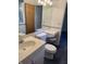 Well-lit bathroom featuring a vanity with a sink, toilet, and make-up area at 5927 Meadowood Dr, Speedway, IN 46224
