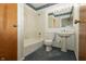 Bright bathroom features a bathtub with shower and a vanity with blue carpet at 5927 Meadowood Dr, Speedway, IN 46224