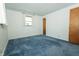 Bedroom with blue carpet, white walls, and a window at 5927 Meadowood Dr, Speedway, IN 46224