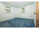 Bedroom features two windows and blue carpet at 5927 Meadowood Dr, Speedway, IN 46224