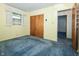 Bedroom featuring closet and blue carpet at 5927 Meadowood Dr, Speedway, IN 46224