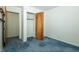 Bedroom with wood door, closet and blue carpet flooring at 5927 Meadowood Dr, Speedway, IN 46224