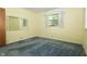 Bedroom featuring a large window, neutral paint and blue carpet at 5927 Meadowood Dr, Speedway, IN 46224