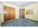 Bedroom featuring closet and blue carpet at 5927 Meadowood Dr, Speedway, IN 46224