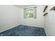 Cozy bedroom featuring a window, neutral paint, blue carpet and natural light at 5927 Meadowood Dr, Speedway, IN 46224