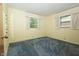 Bedroom featuring two windows and blue carpet at 5927 Meadowood Dr, Speedway, IN 46224
