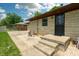 Home's entrance with secure door and backyard seating space at 5927 Meadowood Dr, Speedway, IN 46224