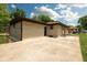 Side view of home shows stone exterior, patio, and access to backyard at 5927 Meadowood Dr, Speedway, IN 46224