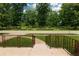 View from the porch with a well manicured lawn and mature trees at 5927 Meadowood Dr, Speedway, IN 46224