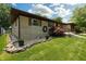 Charming home with stone exterior, manicured lawn, and decorative landscaping at 5927 Meadowood Dr, Speedway, IN 46224