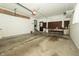 Spacious garage with white walls, a work bench, pegboard and a large overhead door to the driveway at 5927 Meadowood Dr, Speedway, IN 46224