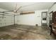 Spacious garage with white walls, a work bench and a large overhead door to the driveway at 5927 Meadowood Dr, Speedway, IN 46224