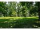 Expansive green space with mature trees and covered picnic area in the distance at 5927 Meadowood Dr, Speedway, IN 46224