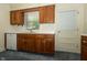 Charming kitchen with wood cabinets, white countertops, and a window at 5927 Meadowood Dr, Speedway, IN 46224