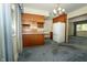 Traditional kitchen with wood cabinets, updated appliances, and carpeted dining area at 5927 Meadowood Dr, Speedway, IN 46224