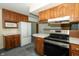 Charming kitchen featuring wood cabinets and updated stainless steel appliances at 5927 Meadowood Dr, Speedway, IN 46224