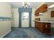 Classic eat-in kitchen with wood cabinetry, bar, and large window at 5927 Meadowood Dr, Speedway, IN 46224