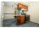 Eat-in kitchen featuring wood cabinets, appliances, and access to carpeted living area at 5927 Meadowood Dr, Speedway, IN 46224