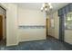 Bright living room with patterned wallpaper, window, and a ceiling light fixture at 5927 Meadowood Dr, Speedway, IN 46224