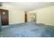 Bright living room with view into kitchen and a blue carpet at 5927 Meadowood Dr, Speedway, IN 46224