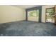 Spacious living room with cozy blue carpet and ample natural light at 5927 Meadowood Dr, Speedway, IN 46224