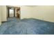 Open floorplan living room with blue carpet connecting to the kitchen at 5927 Meadowood Dr, Speedway, IN 46224