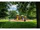 Community playground with multiple slides, climbing structures, and benches at 5927 Meadowood Dr, Speedway, IN 46224