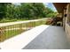 View of the covered concrete porch with decorative metal railing at 5927 Meadowood Dr, Speedway, IN 46224