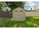 Backyard storage shed in a fenced yard with grassy lawn at 5927 Meadowood Dr, Speedway, IN 46224