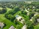 Bird's-eye view showing the property's access to a community pool, tennis courts, and lush greenery at 6118 Deerwood Dr, Greenwood, IN 46143