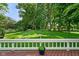 Private backyard with manicured lawn and mature trees, as seen from a spacious deck at 6118 Deerwood Dr, Greenwood, IN 46143