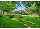 Lush backyard featuring a vibrant lawn and lovely landscaping surrounding the home's exterior at 6118 Deerwood Dr, Greenwood, IN 46143